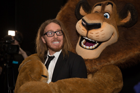 Tim enjoying an embrace from Alex the Lion Photographer Andrew Morley, Image courtesy ACMI